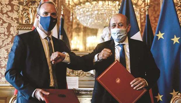 French Foreign Minister Jean-Yves Le Drian (right) elbows with Britainu2019s Foreign Secretary Dominic Raab after signing the agreement in Paris yesterday. ( AFP)