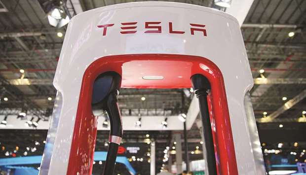 A Tesla charging station is pictured during the media day for the Shanghai Auto Show (file). Excluding items, Tesla posted a profit of $1.45 per share, easily topping analyst expectations for a profit of 98 cents per share.