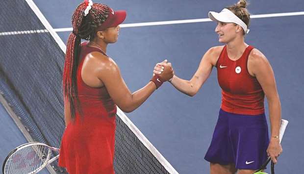 Czech Republicu2019s Marketa Vondrousova (right) shakes hands with Japanu2019s Naomi Osaka after winning her third round match at the Ariake Tennis Park in Tokyo yesterday. (Reuters)