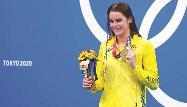 Australiau2019s Kaylee McKeown poses with her medal on the podium after the final of the womenu2019s 100m backstroke swimming event during the Tokyo 2020 Olympic Games at the Tokyo Aquatics Centre  on Tuesday. (AFP)