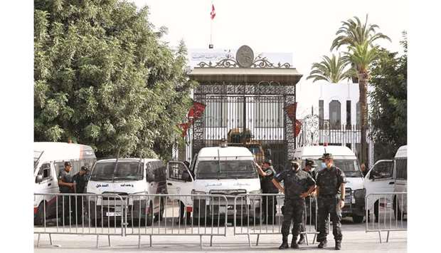 Police officers stand guard outside the parliament building in Tunis, on Tuesday.
