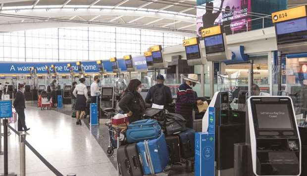 Passengers wait at check-in desks in the departures hall in Terminal 5 at London Heathrow Airport. Based on its latest passenger survey conducted in May, the International Air Transport Association said most air travellers are now confident about the safety of air travel and support mask-wearing in the near-term.