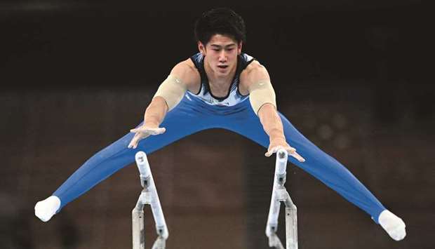 Japanu2019s Daiki Hashimoto competes in the parallel bars during the menu2019s all-around final at the Tokyo 2020 Olympic Games at Ariake Gymnastics Centre in Tokyo yesterday. (AFP)