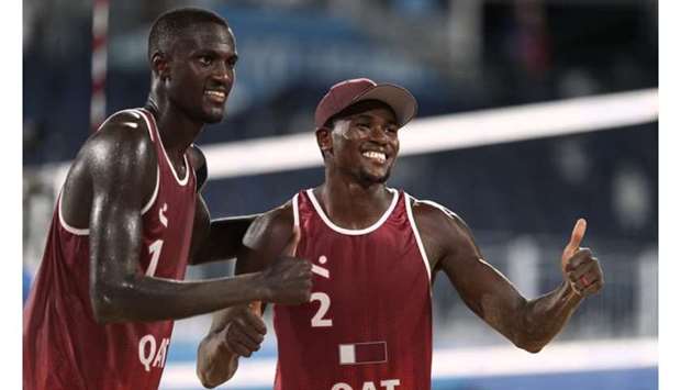 Qataru2019s Cherif Younousse (left) and Ahmed Tijan celebrate after their win in Tokyo on Wednesday. (Reuters)