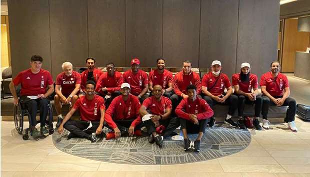 Qataru2019s athletics contingent pose after arriving at the Olympic Village in Tokyo on Wednesday.