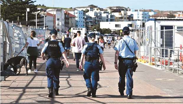 Police patrol near Bondi Beach in Sydney as authorities announced that millions of residents will spend another month in lockdown due to a still-fast-growing Covid-19 outbreak.