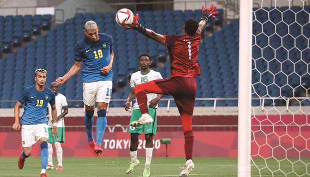 Brazilu2019s Richarlison (centre) scores against Saudi Arabia in their Group D match at the Saitama Stadium yesterday. (Reuters)