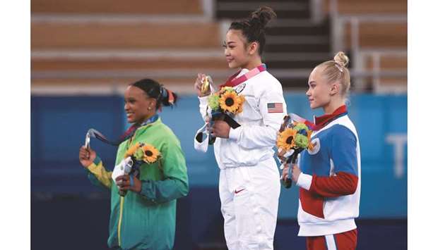 Gold medallist Sunisa Lee (centre), runner-up Rebeca Andrade and bronze medallist Angelina Melnikova (right) pose with their medals during the medal ceremony after the artistic Gymnastics womenu2019s individual all-around final. (Reuters)