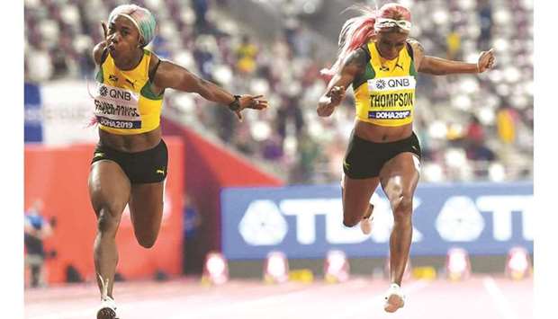 In this file photo taken on September 29, 2019, Jamaicau2019s Shelly-Ann Fraser-Pryce (left) finishes first ahead of Jamaicau2019s Elaine Thompson in the Womenu2019s 100m final at the 2019 IAAF World Athletics Championships at the Khalifa International Stadium in Doha. (AFP)