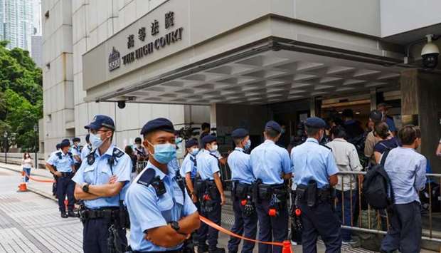 Police stand guard outside the High Court during court hearing of Tong Ying-kit, the first person charged under a new national security law, in Hong Kong, China. REUTERS