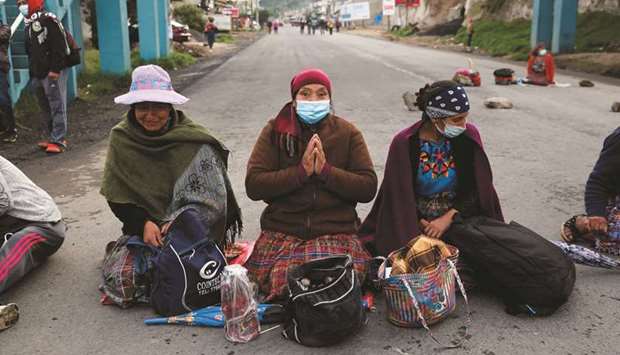 Mayan indigenous women block a road during a protest demanding the resignation of Guatemalan President Alejandro Giammattei and Attorney-General Maria Porras, in San Cristobal Totonicapan, Guatemala.