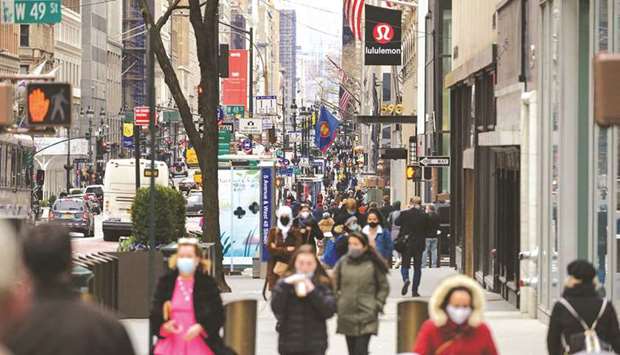 People walk on a busy 5th Avenue in New York City. The US economy grew solidly in the second quarter, pulling the level of gross domestic product above its pre-pandemic peak, as massive government aid and vaccinations against Covid-19 fuelled spending on goods and travel-related services.