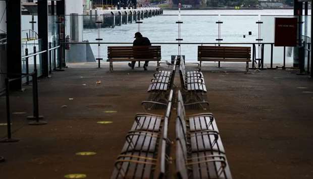 A lone man sits on a bench at the quiet Circular Quay during a lockdown to curb the spread of a coronavirus disease outbreak in Sydney, Australia on July 28. REUTERS