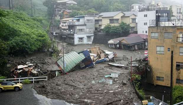 Houses damaged by a mudslide are seen following heavy rain at Izusan district in Atami, Japan