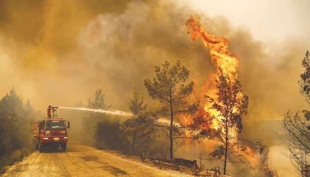 A firefighter works to extinguish a fire near the town of Manavgat, east of the resort city of Antalya.