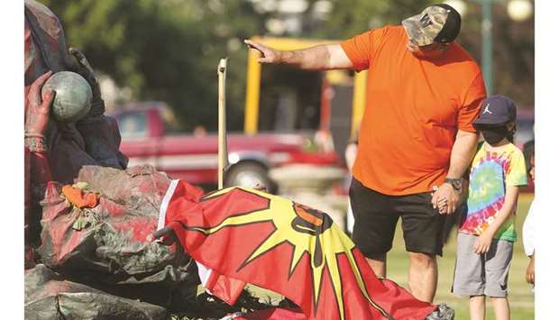 A defaced statue of Queen Victoria lies after being toppled during a rally in Winnipeg, Manitoba, Canada.