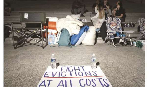 A sign is seen on the ground as lawmaker Cori Bush spends the night outside the US Capitol to call for an extension of the federal eviction moratorium.