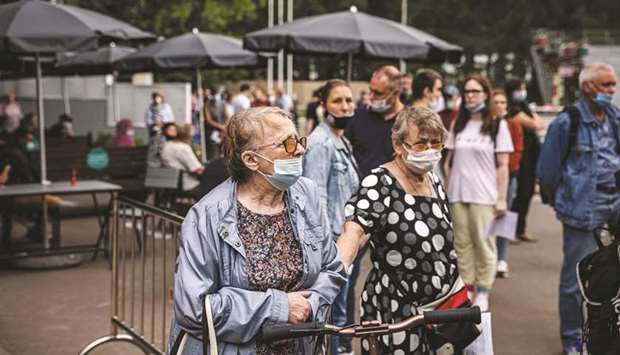 People wait in line to get the coronavirus vaccine at the vaccination centre in Moscowu2019s Sokolniki Park.