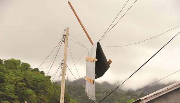 Debris hangs from utility lines in Sandy Bay, St. Vincent and the Grenadines, following the passing of Hurricane Elsa in an area on the north coast.
