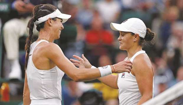 Australiau2019s Ashleigh Barty (right) embraces compatriot Ajla Tomljanovic after winning the womenu2019s quarter-final match at the Wimbledon at The All England Tennis Club in Wimbledon, southwest London, yesterday. (AFP)