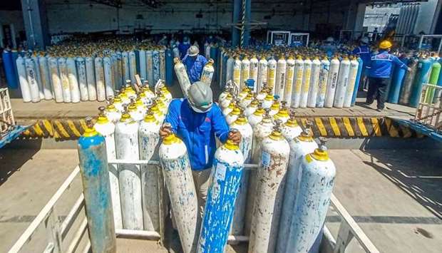 Workers for an oxygen supplies company prepare cylinders for distribution in Semarang, Central Java on July 6, amid a surging demand for oxygen amid a record spike of Covid-19 coronavirus infections including the Delta variant