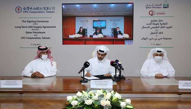 HE Saad bin Sherida al-Kaabi signs the SPA with Shun-Chin Lee at a virtual ceremony as other officials look on.