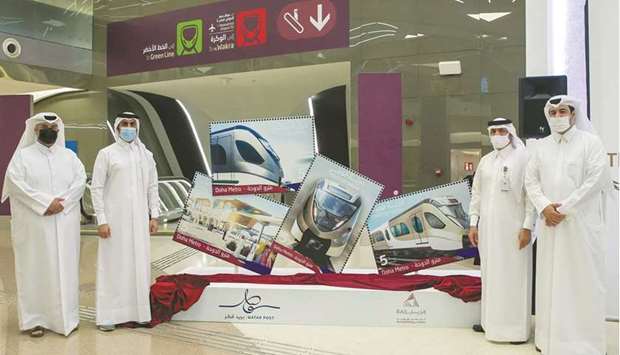 Senior Qatar Rail and Qatar Post officials at the unveiling of the new Doha Metro stamps at Msheireb station.