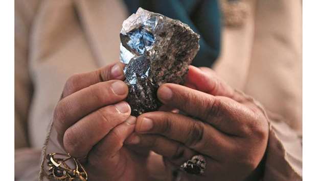 A member of the Botswana cabinet holds a 1,174-carat diamond in Gaborone, Botswana, on July 7, 2021, that the Lucara Botswana found during an eleven day production run in June 2021.