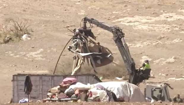 Israeli forces tear down tent dwellings of Palestinians, according to rights groups, in the village of Humsah, in the occupied West Bank in this screengrab taken from video, yesterday.