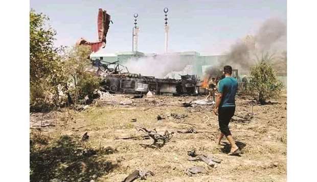 Damage is seen amid smoke following rocket attacks at Anbar province, in Al-Baghdadi, Iraq yesterday.