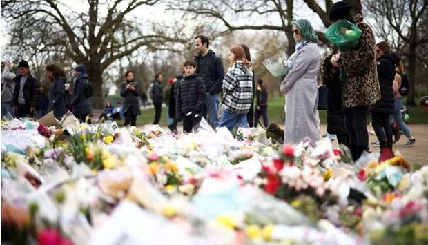 People observe a memorial site at the Clapham Common Bandstand, following the kidnapping and murder of Sarah Everard, in London, Britain, March 21. REUTERS
