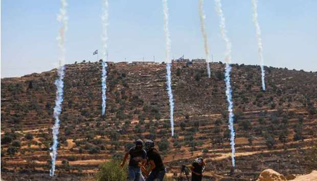 Tear gas grenades are dropped by an Israeli drone to disperse Palestinian demonstrators during a protest against Israeli settlements, in Beita, in the Israeli-occupied West Bank. REUTERS