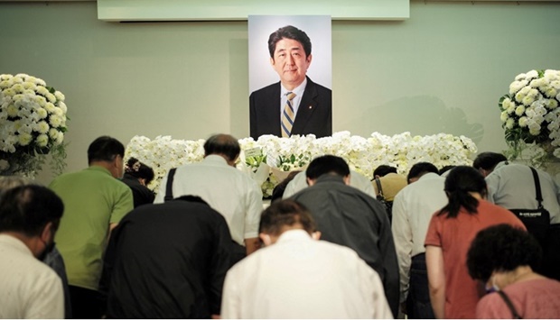People pay their condolences to former Japanese prime minister Shinzo Abe at the Japan-Taiwan Exchange Association office in Taipei on July 11, 2022.