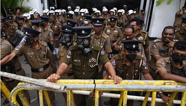 Members of police stand guard in front of the police headquarters during a protest by demonstrators demanding actions against authorities over attacks on protestors and media amid ongoing economic crisis in Colombo on July 11, 2022. REUTERS