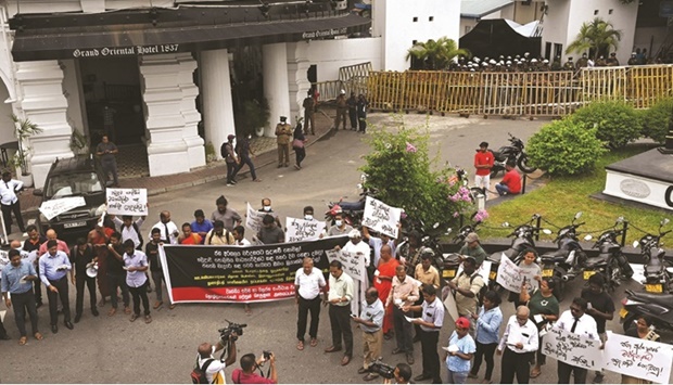 People take part in a protest in front of the police headquarters demanding action against authorities over attacks on protesters and media amid the ongoing economic crisis in Colombo, yesterday.