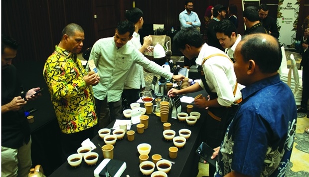 Indonesian ambassador Ridwan Hassan takes part in the coffee cupping event.