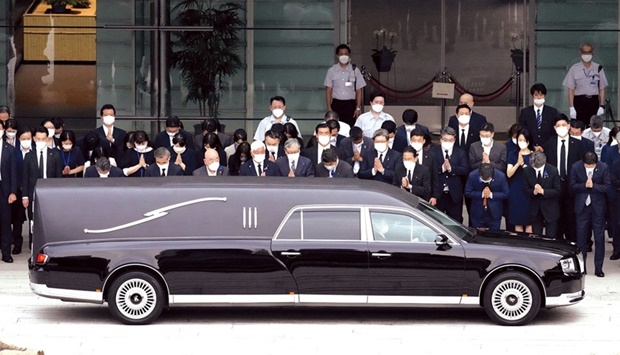 A hearse carrying the body of former Japanese prime minister Shinzo Abe, makes a brief visit to the Prime Ministeru2019s Office, as Japanu2019s Prime Minister Fumio Kishida, officials and employees offer prayers, in Tokyo, yesterday.