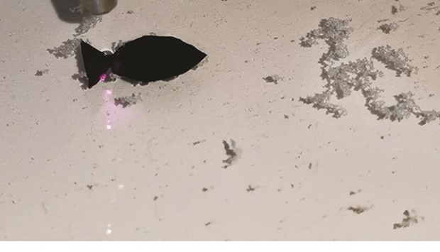 A fish-shaped robot, which researchers say can suck up microplastics in shallow water, moves under the direction of a near-infrared (NIR) light, in this screen grab taken from a handout video provided to Reuters, yesterday.