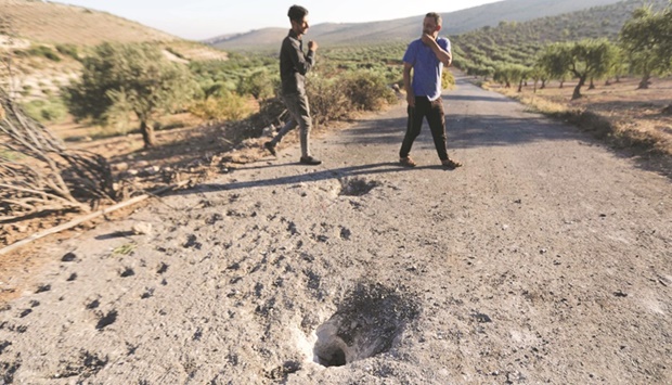 People inspect the site where a US drone targeted Maher al-Agal, a leader in the Islamic State group, near the village of Khaltan, near Jindires in northern Syria, yesterday.
