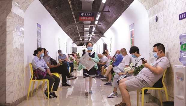Residents spend their time in an air-raid shelter to escape summer heat amid a heatwave warning in Nanjing, Jiangsu province.