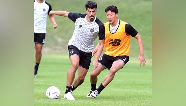 Al Saddu2019s Baghdad Bounedjah (left) and Jung Woo-young train during a pre-season camp in Vienna.