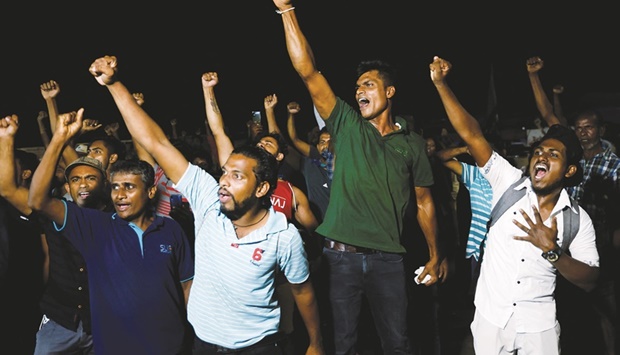 People dance as they celebrate the resignation of Sri Lankau2019s President Gotabaya Rajapaksa at a protest site, in Colombo, yesterday.