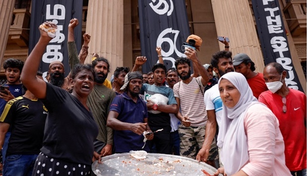 Demonstrators celebrate while offering milk rice at the Presidential Secretariat after Parliament Speaker Mahinda Yapa Abeywardena officially announced resignation of president Gotabaya Rajapaksa, amid the country's economic crisis, in Colombo, Sri Lanka. REUTERS
