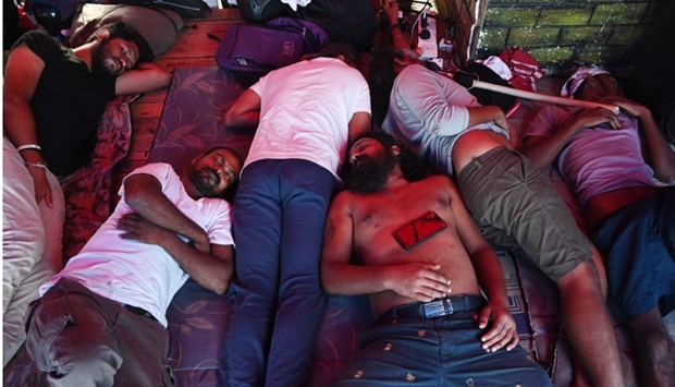 Demonstrators rest in a makeshift tent at a protest arena near Sri Lankan presidential office in Colombo. AFP