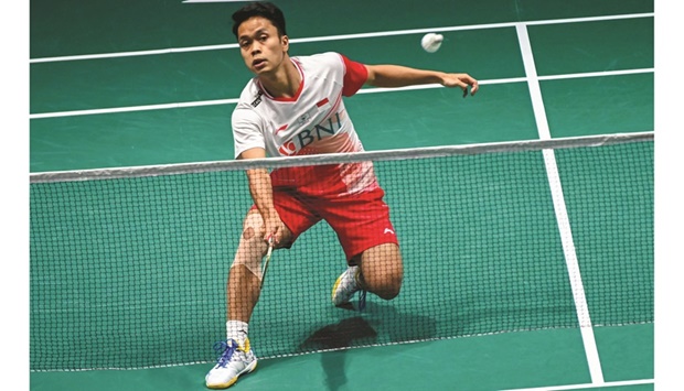 Indonesiau2019s Anthony Sinisuka Ginting hits a return against Singaporeu2019s Loh Kean Yew during their semi-final at the Singapore Open in  Singapore yesterday. (AFP)