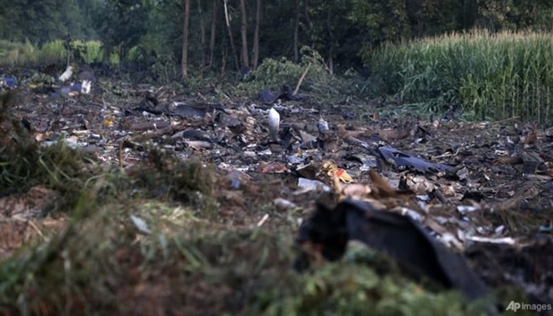 Debris of an Antonov cargo plane is seen in Palaiochori village in northern Greece, Jul 17, 2022, after it reportedly crashed on Saturday near the city of Kavala