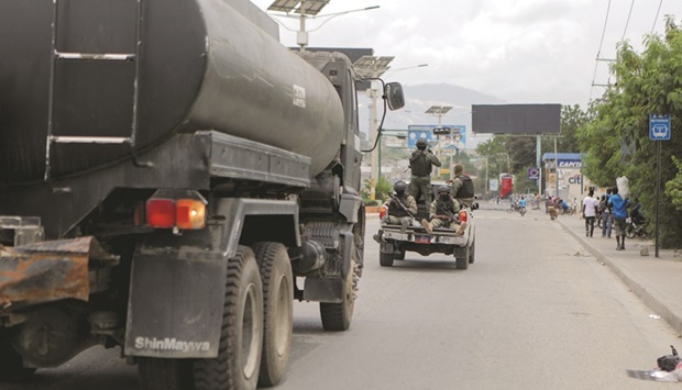 Soldiers escort a tanker truck transporting fuel in Port-au-Prince.