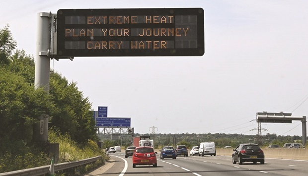 A road sign reads u2018Extreme Heat, Plan your journey, Carry wateru2019, warning motorists about the heatwave forecast for today and tomorrow, on the M11 motorway north of London.