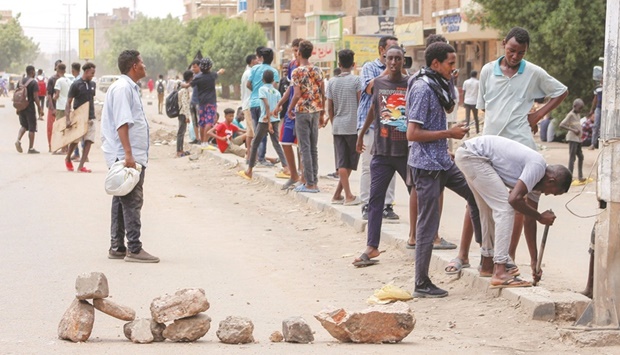 Sudanese protesters barricade a street as they take part in an anti-coup demonstration, in the Daym-Bashdar station area in central Khartoum, yesterday.