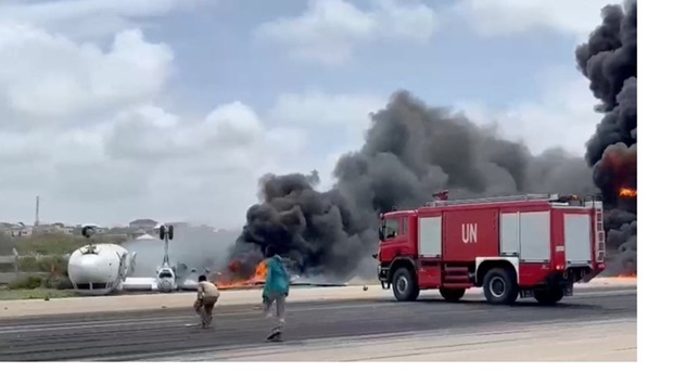 Smoke billows from a plane that flipped over after a crash landing, in Mogadishu, Somalia, in this screen grab obtained from a social media video obtained by Reuters